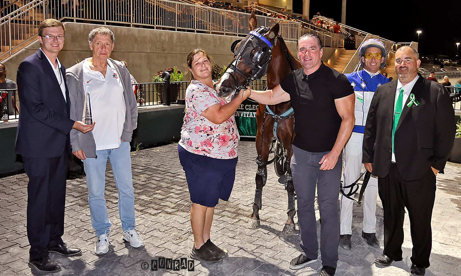 people posing with race horse
